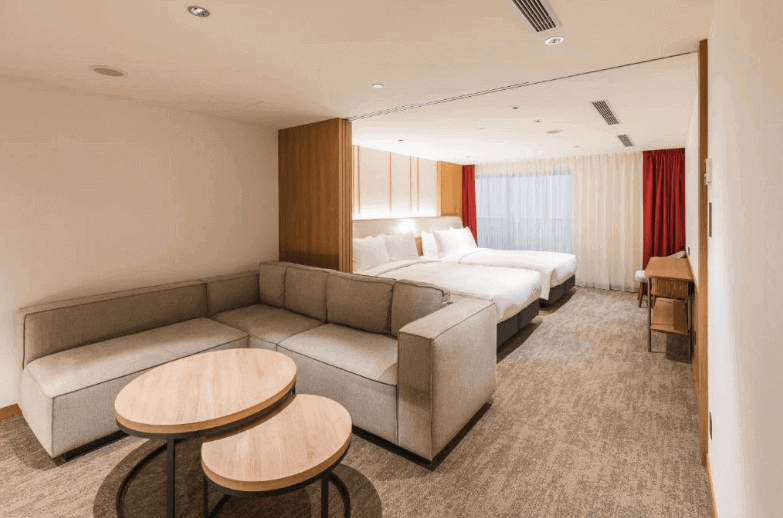 【台北親子飯店】相鐵飯店台北西門的家庭套房，房內設有雙床區域與獨立的大型沙發休息區，空間分配合理，適合家庭或團體入住。