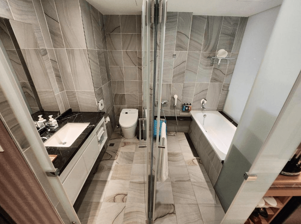 賓利酒店的浴室，採用灰色大理石瓷磚，內部配置淋浴間、浴缸及雙人洗手台，空間寬敞，設計風格簡約又具質感。