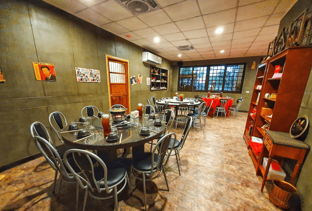 【水里住宿】樂水軒民宿的復古風格用餐區，內部裝飾充滿懷舊氣息，展示牆上掛有老照片與海報，營造濃厚的懷舊氛圍，並配有圓桌與餐椅，適合多人聚餐。