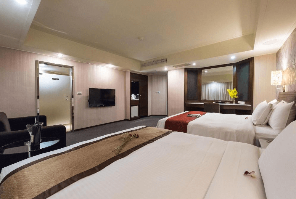 【板橋住宿】馥俐商旅 雙床房，設計簡約現代，房內配有液晶電視、辦公桌與沙發座椅，空間明亮舒適。