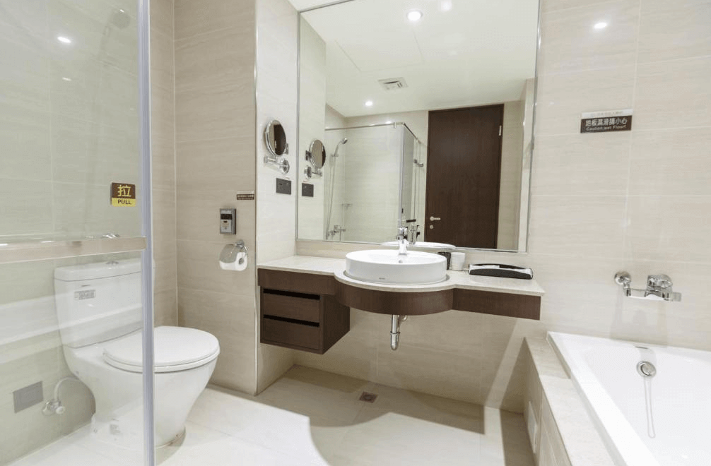 【鳳山住宿】皇家金宸大飯店浴室 明亮潔淨的浴室，配有乾濕分離淋浴間、浴缸與洗手台，大面鏡面設計提升空間感，設施新穎齊全。