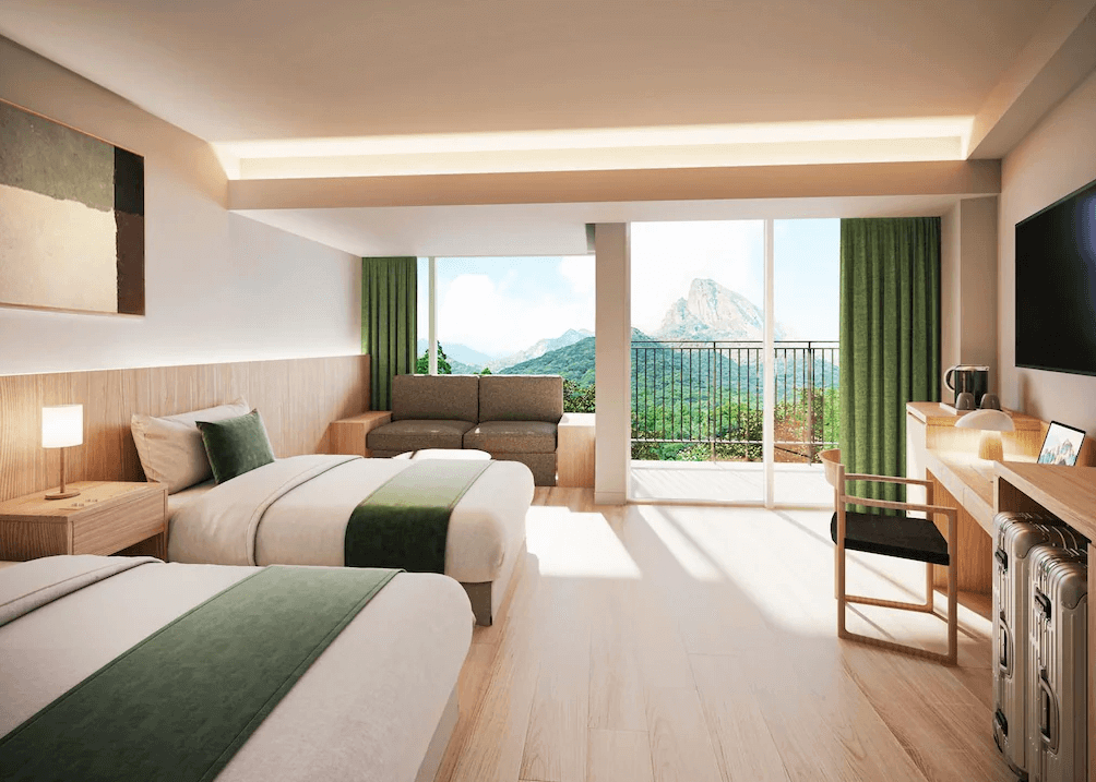 【屋久島住宿】「samana hotel Yakushima 薩馬納飯店屋久島的山景客房，雙床與沙發區以柔和木色搭配綠色系裝飾，房間外可欣賞屋久島山峰與森林景致。」