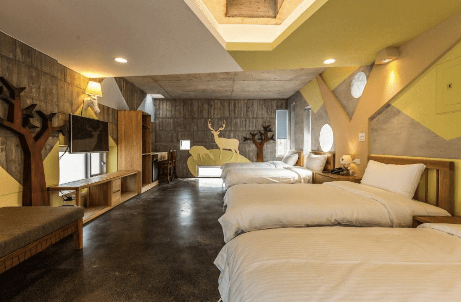 【宜蘭溫泉飯店】「有朋會館親子四人房，房內以原木家具、鹿造型壁飾與森林系彩繪打造童趣氛圍，配置多張大床與寬敞活動空間，風格溫暖而富設計感。」