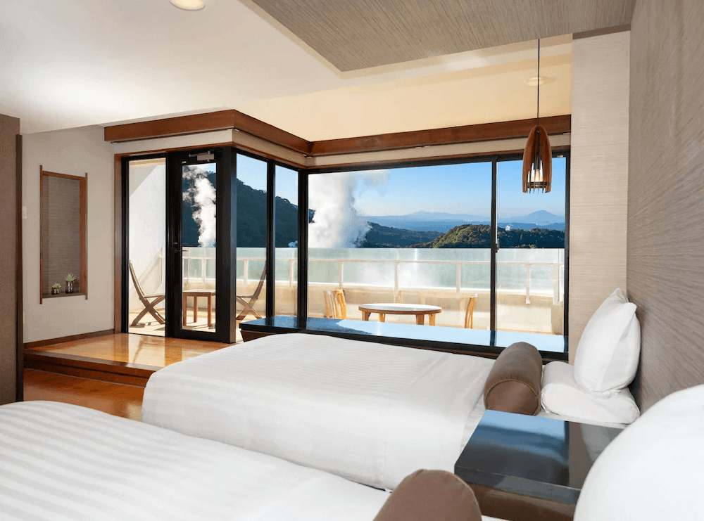 【霧島住宿】霧島國際飯店的客房私人露台，設有獨立的露天風呂泡湯池與休閒躺椅，在藍色調的暮色中營造出寧靜奢華的度假氛圍。